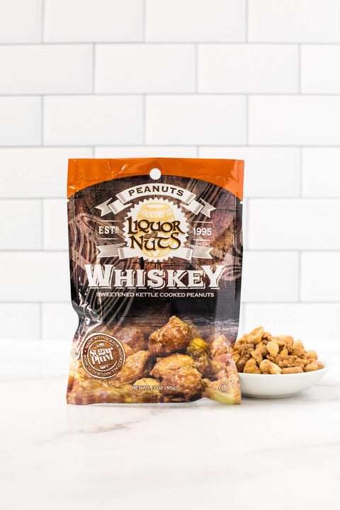 Whiskey flavored peanuts pack with bowl of peanuts, featuring gourmet liquor-inspired snacks perfect for gifting.