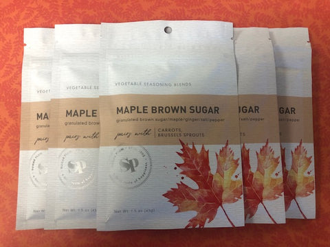 Five-pack of Maple Brown Sugar Vegetable Seasoning on an orange background, featuring maple leaf design packaging.